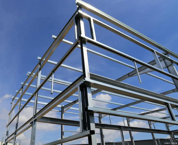 The steel frame of a building under construction, set against a blue sky. This structure is an application for the purlins produced by the CZ purlin making machine.