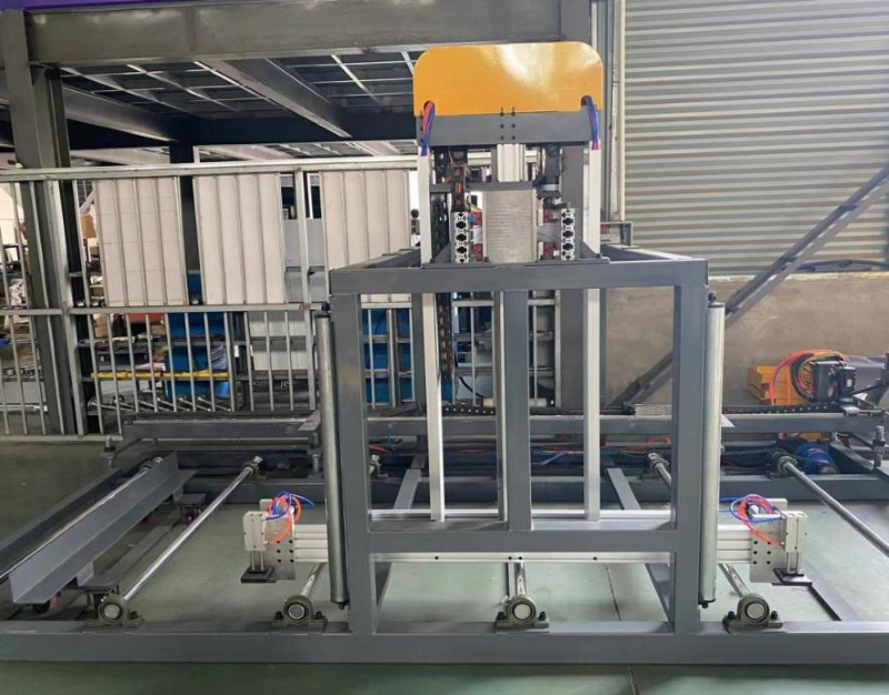 The stacking section of a Fully automatic light steel keel machine, featuring a gray metal frame, guide rails, and pneumatic components in a factory setting.