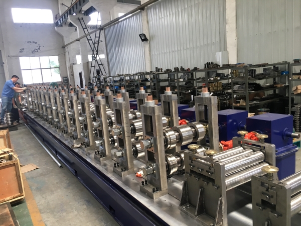 The main roll forming section of the upright pillar production line, showing the series of forming stations and rollers.