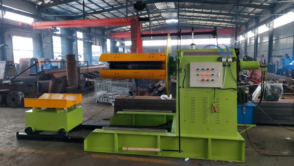 Industrial DeCoiler machine with control panel and material cart.
