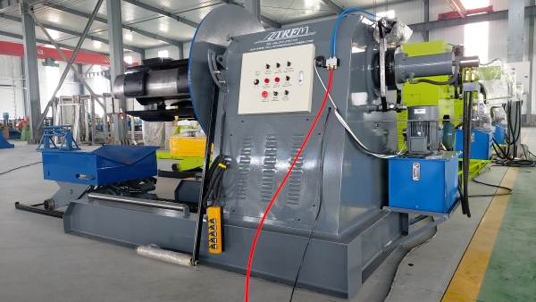 DeCoiler machine with white electrical control panel.