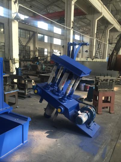 Blue hydraulic entry coil car positioned in a factory workshop, part of a hydraulic slitting line system.