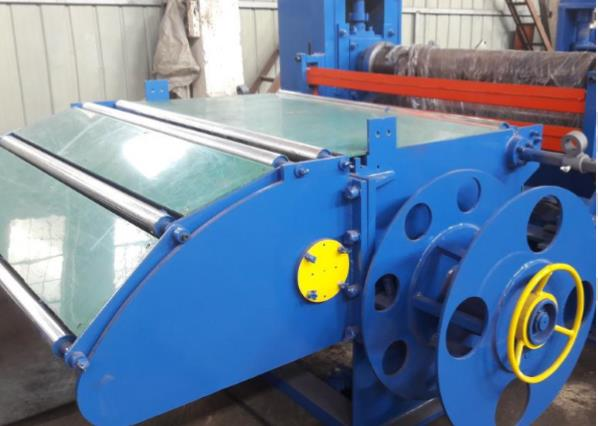 Blue scrap winder unit, part of a hydraulic slitting line, designed to collect and wind trimmed metal strips.